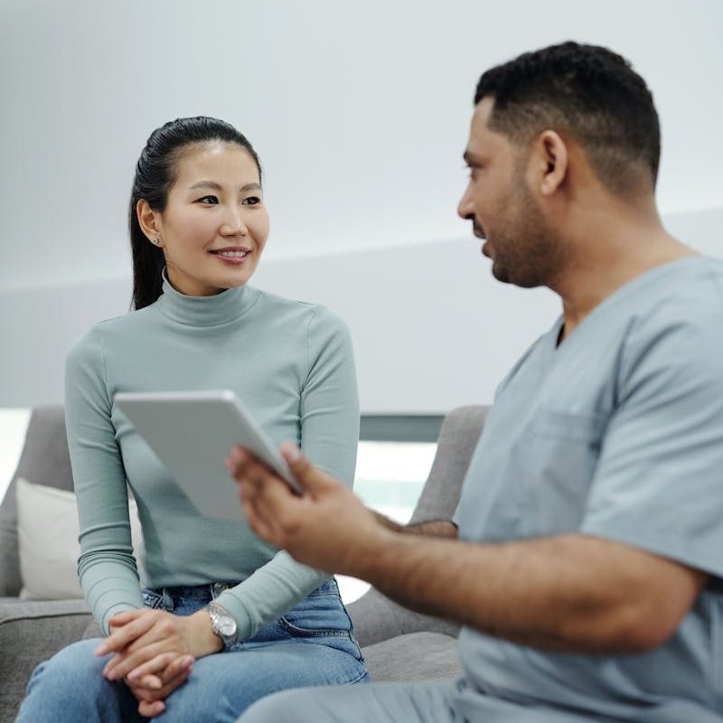 Healthcare professional and patient discussing treatment options in a modern clinic setting.